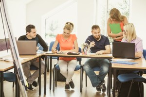 Students and teacher tutor in classroom